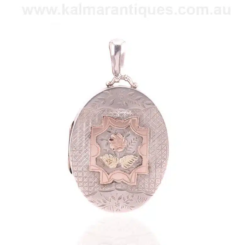 Antique sterling silver locket highlighted with rose and green gold