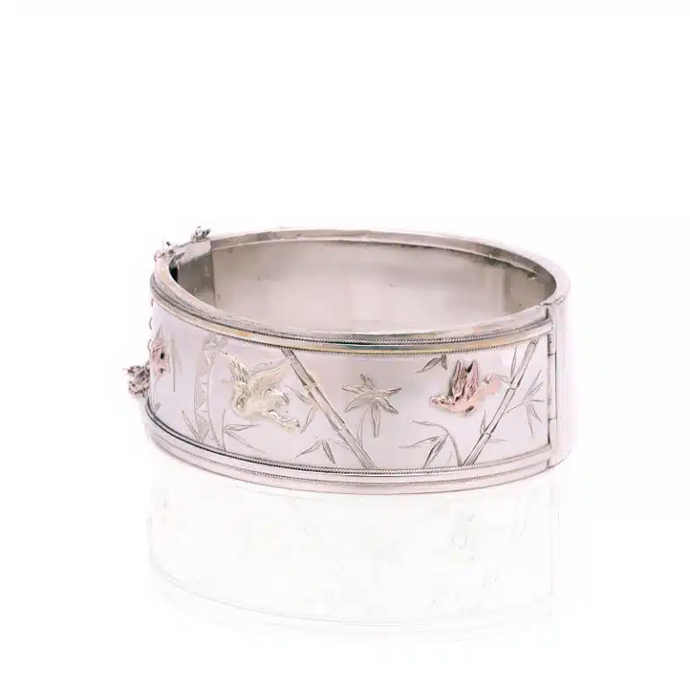 Victorian era antique bangle in sterling silver and highlighted with rose and green gold