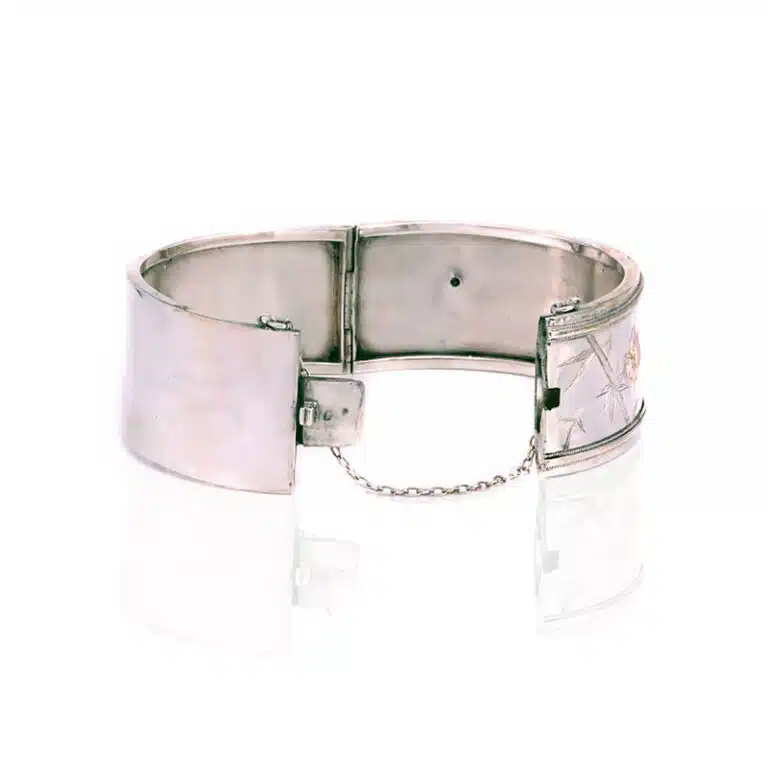 Victorian era antique bangle in sterling silver and highlighted with rose and green gold