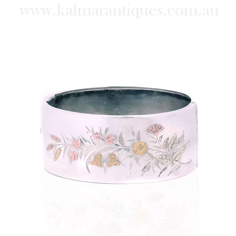 Antique silver hinged bangle highlighted with rose and green gold