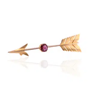 Antique arrow brooch set with a garnet