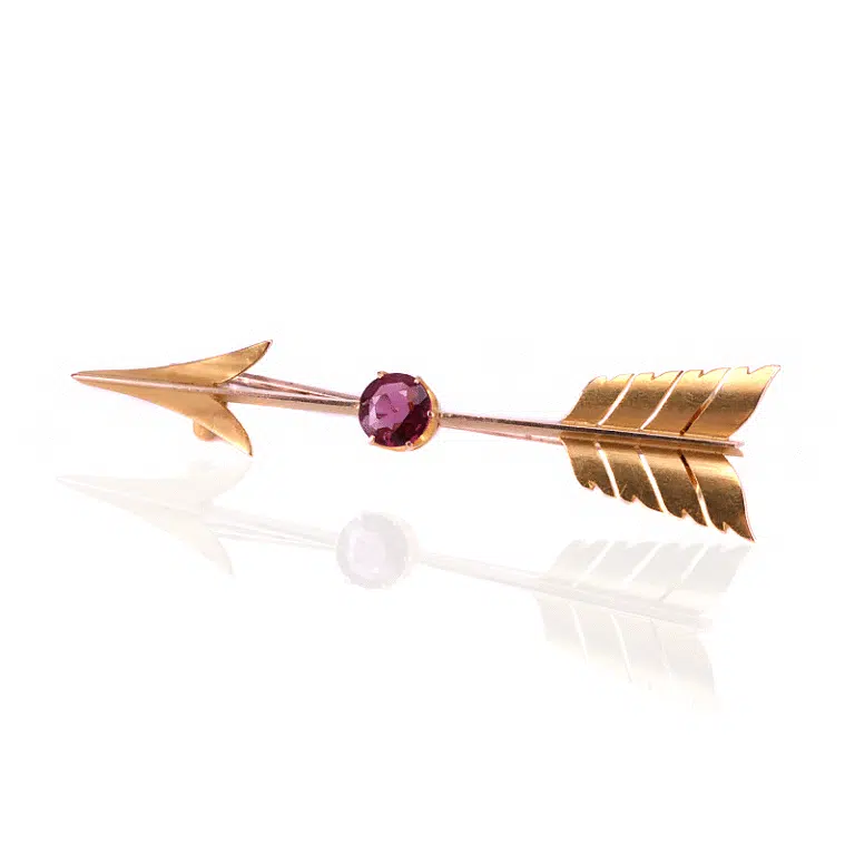 Antique arrow brooch set with a garnet