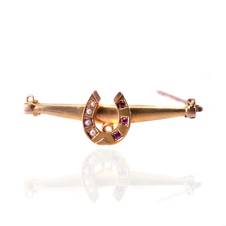 Antique ruby and pearl horseshoe brooch