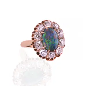 Solid black opal and diamond ring