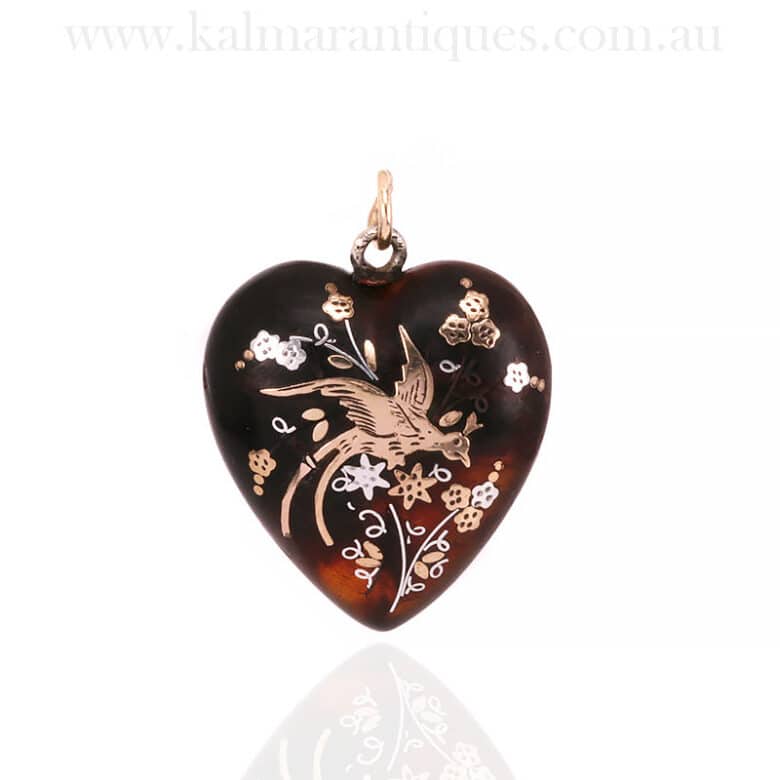Antique pique pendant with a bird of paradiseAntique pique pendant with a bird of paradise