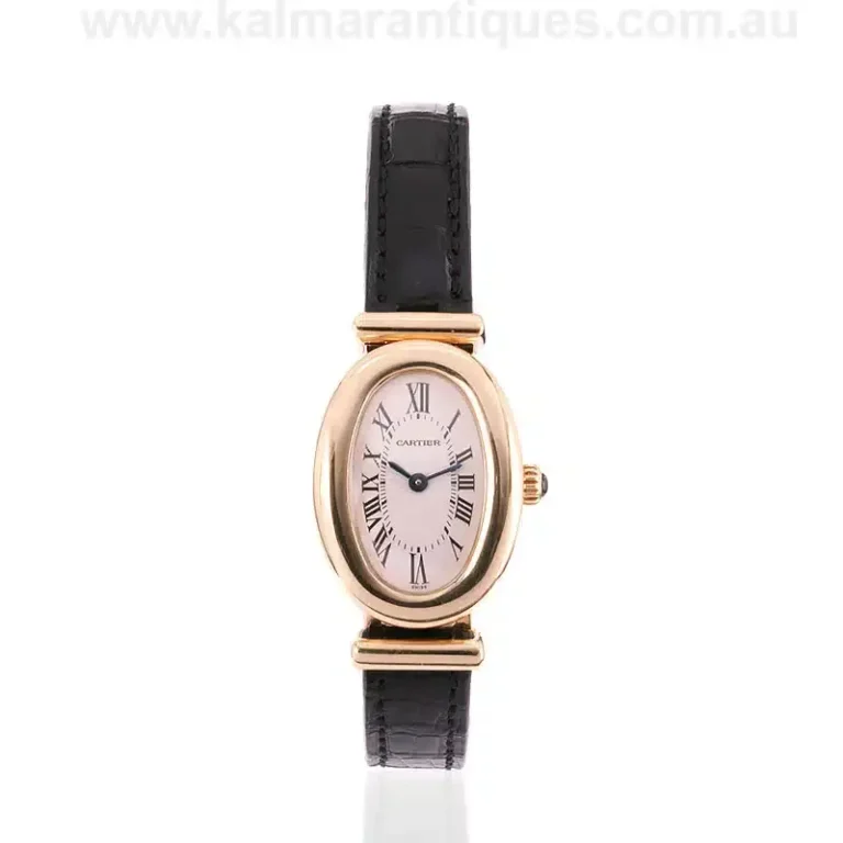 Rare vintage Cartier Baignoire ladies watch featuring its iconic curved oval yellow gold case